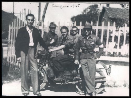 Anonimo, Sangano (To). Nel gruppo di partigiani appartenenti alla 43ª Divisione autonoma De Vitis, primo da destra, appoggiato alla motocicletta, si riconosce Guido Quazza., 1945, CC BY-NC-SA